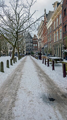 Snowy Amsterdam in winter in the Netherlands at sunset