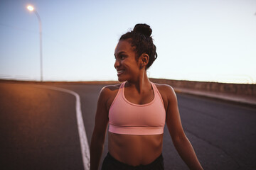 Smiling young woman out for an early morning run