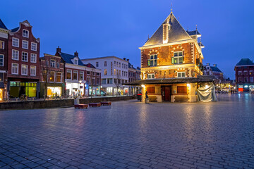 Naklejka premium City scenic from the city Leeuwarden with the Waag building in the Netherlands at sunset