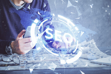 Multi exposure of man's hands holding and using a digital device and seo drawing. search...