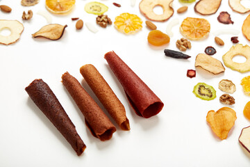 Above view of juicy fruit pastille different colors with fruit and berries in rolls. Concept of natural sweets from berries and fruits and diet vitamin food and vegan food. 