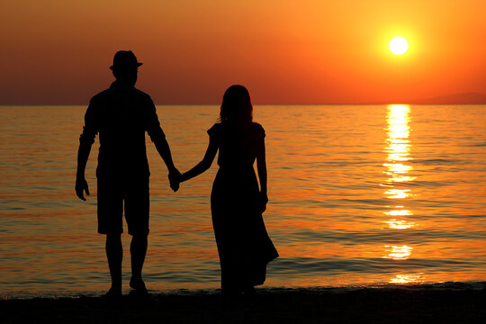 silhouette of a happy loving couple at sunset
