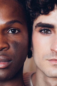 Multiracial gay couple looking at camera