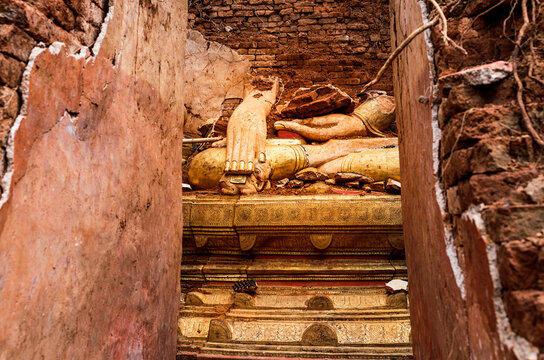 Wall mounted Buddha statue in destructed temple