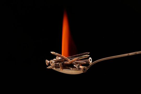 Screws on spoon with flame