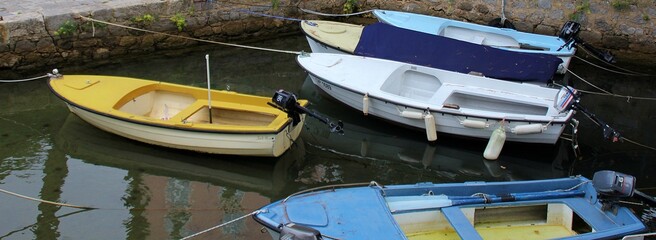 colorful boats moored on the water, blue and yellow colors of small boats, small drawable boats