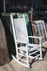 The old white rocking chair is for sale at the antique shop.