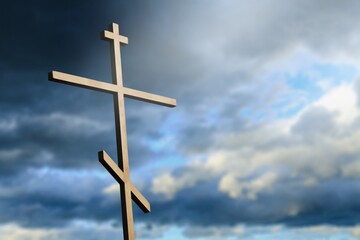 Dramatic religious church cross framed against a moody sky