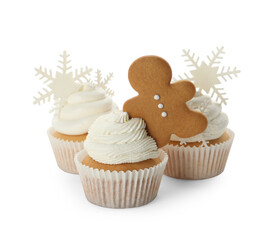 Tasty Christmas cupcakes with snowflakes and gingerbread man on white background
