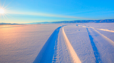 Car tire tracks in fresh snow at Baikal Lake, Siberia