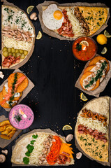 Russian food on wooden background. Assortment dishes of Russian cuisine - borscht and pancakes. Top view. Copy space.