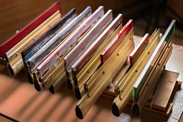squeegees on wooden desk side view. serigraphy production. printing images on t-shirts by silk...