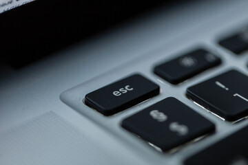 Fototapeta na wymiar Computer keyboard with focus on the ESC button, macro. Exit concept