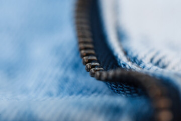 Metal zipper and blue jeans texture, macro. Fashion denim
