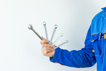 A man's hand with a construction tool on a white background.	
