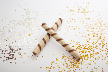 Light-colored cookies in a bright glitter decor for advertising on a white background