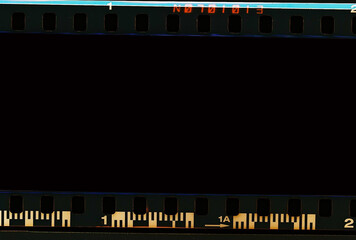 Film scan. Digital number and bezel on film photographs scanned. 35mm film frames strip scanned with signs of usage on bezel. blank old film strip frame background. Retro films border with numbers.