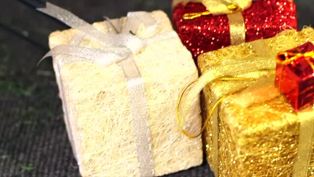 Christmas gift holiday decoration concept. Glitter sparkly presents tied with a bow red, gold, white, silver, shallow depth of field, 