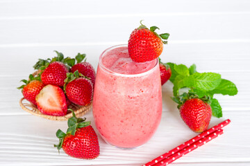 Strawberry yogurt fruit juice smoothie pink colorful fruit juice milkshake blend beverage healthy high protein the taste yummy In glass drink episode morning on white wood background.
