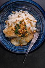 white cod with homemade basil pesto and roasted pine kernels