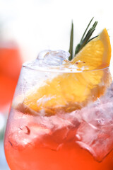 on a sunny summer day, there is an aperol with ice on the table