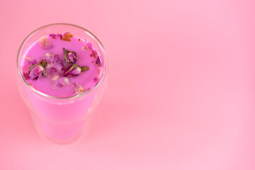 Pink rose milk with rose petals. Healthy drink moon milk. Copy space.