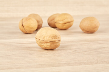 Walnuts lie in the center on a wooden background
