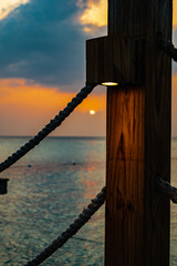 wooden jetty illuminated at sunset