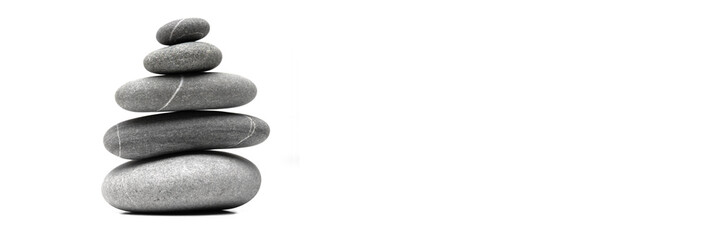 Pyramid of the balanced grey stones isolated on white background with copy space. Banner.