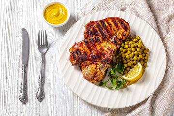 grilled pork t-bone steaks with boiled green peas