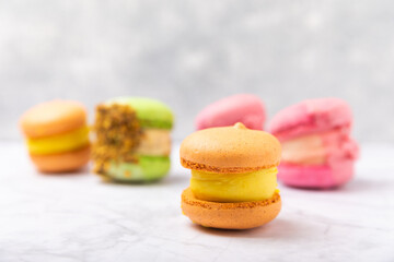 Tasty macarons on a marble background. colorful almond berry cookies.Culinary and cooking concept.Side view.Copy space.