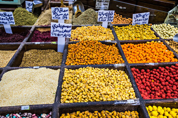 Fototapeta premium Spices, nuts and sweets shop on the market in Amman downtown, Jordan. Choice of Arabic spices on the Middle East bazaar, Jordan