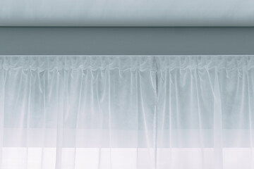 White curtains weigh on ceiling ledge. Curtain interior decoration in living room.