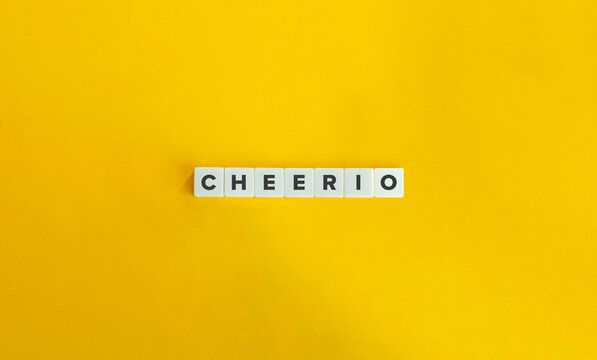 Cheerio Word on Letter Tiles on Yellow Background. Minimal Aesthetics.
