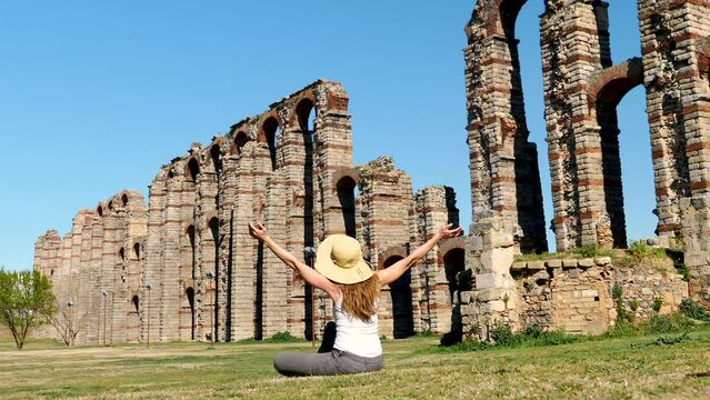 happy tourist woman in Merida- aqueduct of los Milagros