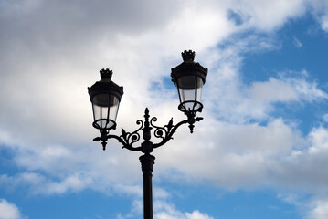 Fototapeta na wymiar Closeup of vintage street light on beautiful cloudy sky background