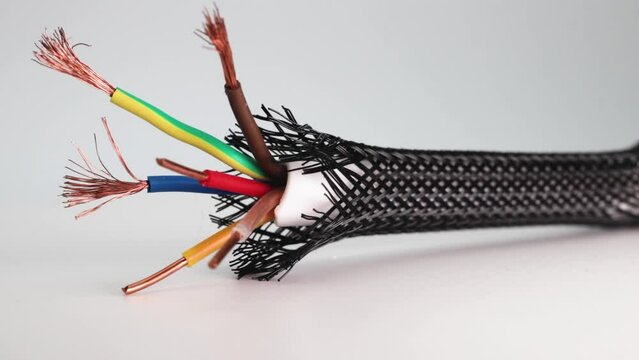 Electric copper cable in isolation on a white background. Installation of electrical cable. Wire insulation in difficult conditions. Close-up.
