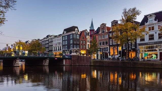 Day to Night Time Lapse with clouds and boats in Amsterdam, The Netherlands
