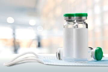 Bottles with covid-19 vaccine remedy for illness epidemic medicine drug stands on table