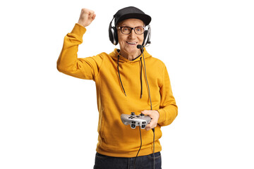 Happy elderly man with headphones and joystick gesturing win