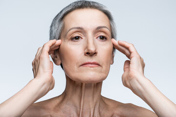 middle aged woman with wrinkles isolated on grey