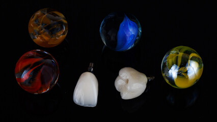 two ceramic crowns with colored glass beads, top view on a black background