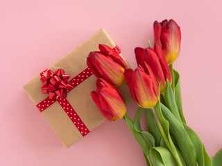 Red tulips and sheet of paper with ribbon and bow number 8 on pink. Concept for March 8 International Women's Day, Valentine's Day.