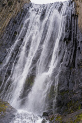 Fototapeta na wymiar Mountain waterfall in the forest. Waterfall view. Waterfall in mountains. Waterfall pool