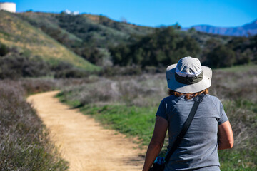 Fototapeta na wymiar A Beautiful, Healthy and Mature Woman Hiking on a California Chaparral Trail 