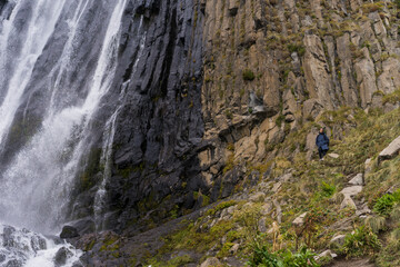 Mountain waterfall in the forest. Waterfall view. Waterfall in mountains. Waterfall pool
