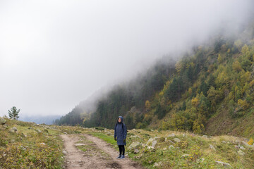 Obraz premium Woman traveller, tourist with a backpack in mountains. Active life concept.