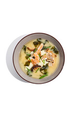 Japanese food - miso soup with tofu, wakame, prawn and shiitake mushroom. Miso soup with shrimp in ceramic bowl on isolated white background.