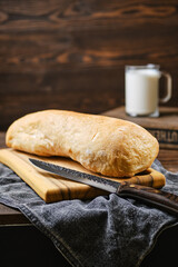 Freshly baked ciabatta on wooden table