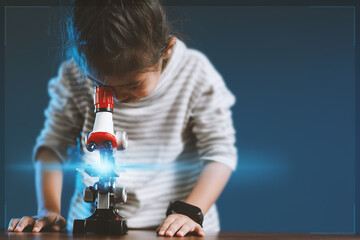 Little girl using a microscope and wants to be a scientist, education, learning for new generations of children, creativity.